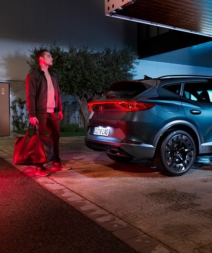 woman stepping out of a cupra formentor vehicle