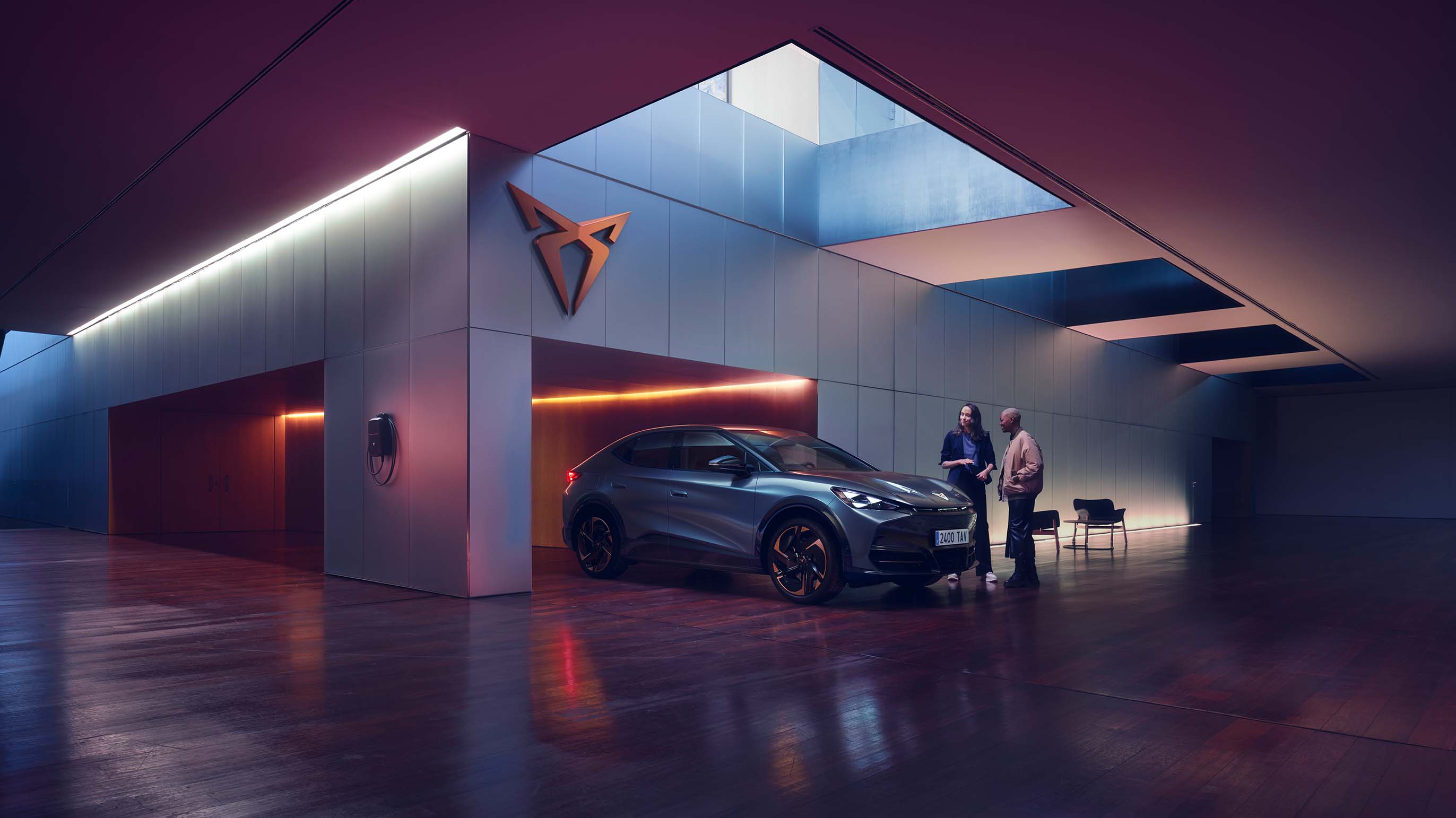electric suv plugged into a wallbox in a minimalist concrete driveway, driver out of car, showcasing sleek automotive design and home ev charging station